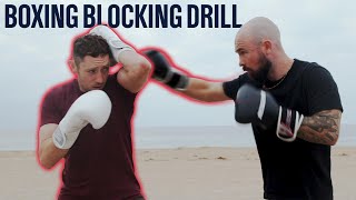 How To Block A Punch  Defensive Blocking Drill [upl. by Airdnazxela959]